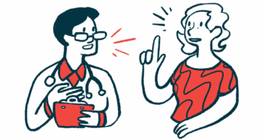 A woman talks with a medical professional.