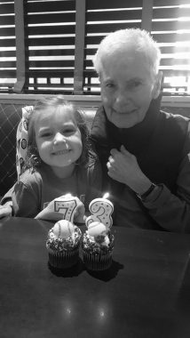 remembering mom | Rett Syndrome News | Ryan Babiarz smiles alongside her grandmother, Jackie in a black-and-white photo from October 2016. Two cupcakes have a 7 and a 3 candle for her 73rd birthday.