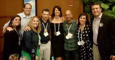 Rett syndrome conference | Rett Syndrome News | photo of four men and four women, arms linking one another