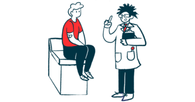 A doctor holding a clipboard speaks with a patient seated on an examining table.