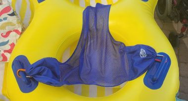 falling | Rett Syndrome News | Blue netting is attached to a yellow inner tube by carabiners as a way to allow Cammy to float in the water