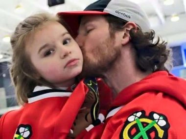 make the most of life | Rett Syndrome News | Hockey player Duncan Keith holds Cammy and kisses her on the cheek. Both are wearing Chicago Blackhawks jerseys.
