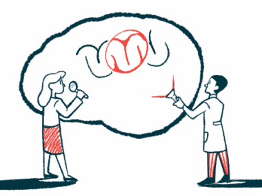 Two researchers stand beside an enlarged image of a brain.