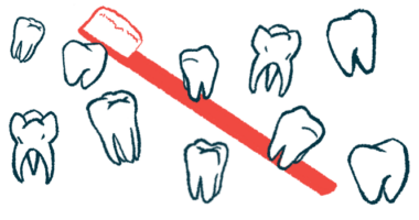 Nearly a dozen individual teeth are pictured with a toothbrush in the background.