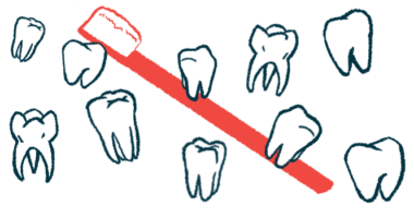 Nearly a dozen individual teeth are pictured with a toothbrush in the background.