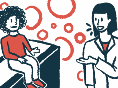 A doctor speaks with a child seated on an exam table.