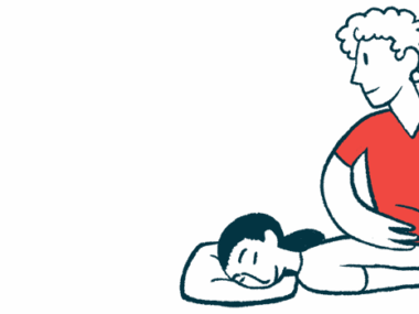 A woman lies on a table while a physical therapist works on her back.