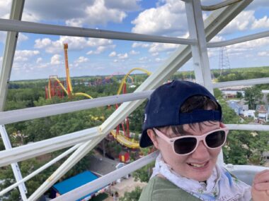 A girl is shown on a ride at an amusement park.